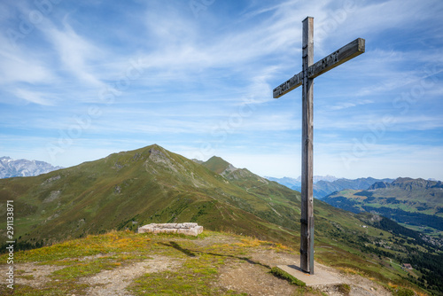 View of the Alpine mountain range from the top of the Scalottas peak in Switzerland with a religious cross - 1