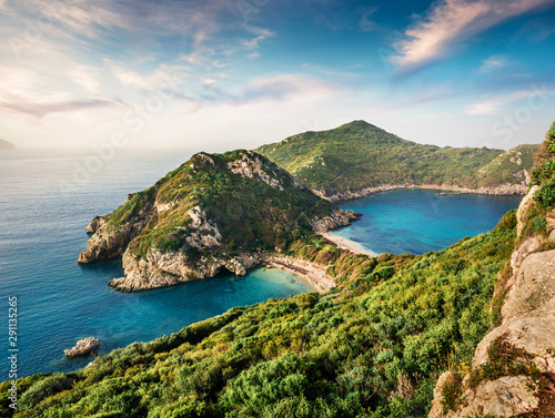 Fabulous spring view of Pirates Bay, Afionas village location.Perfect morning seascape of Ionian Sea. Fantastic outdoor scene of Corfu island, Greece, Europe. Beauty of nature concept background.