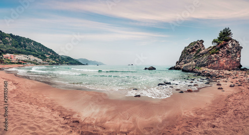 Panoramic spring view of Pelekas beach. Amazing morning seascape of Ionian Sea. Beautiful landscape of Corfu island, Kontogialos health resort, Greece, Europe. Traveling concept background.