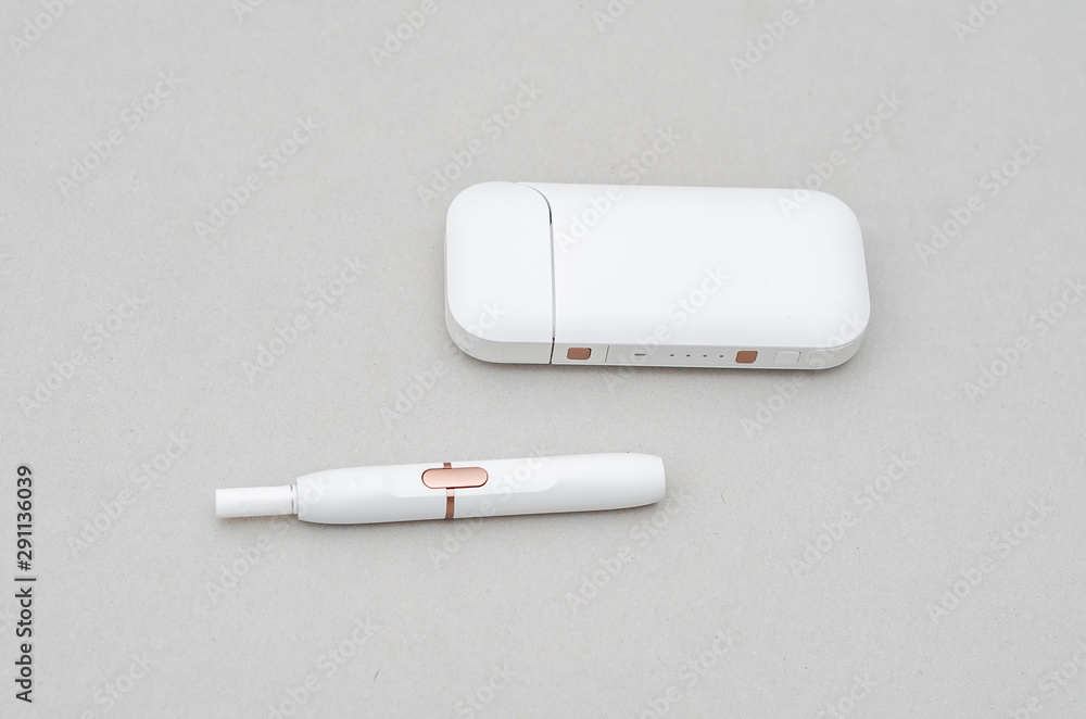 Box-case with a mouthpiece for an electronic cigarette with a white color on a gray background Box-case with a mouthpiece for an electronic cigarette with a white color on a gray background