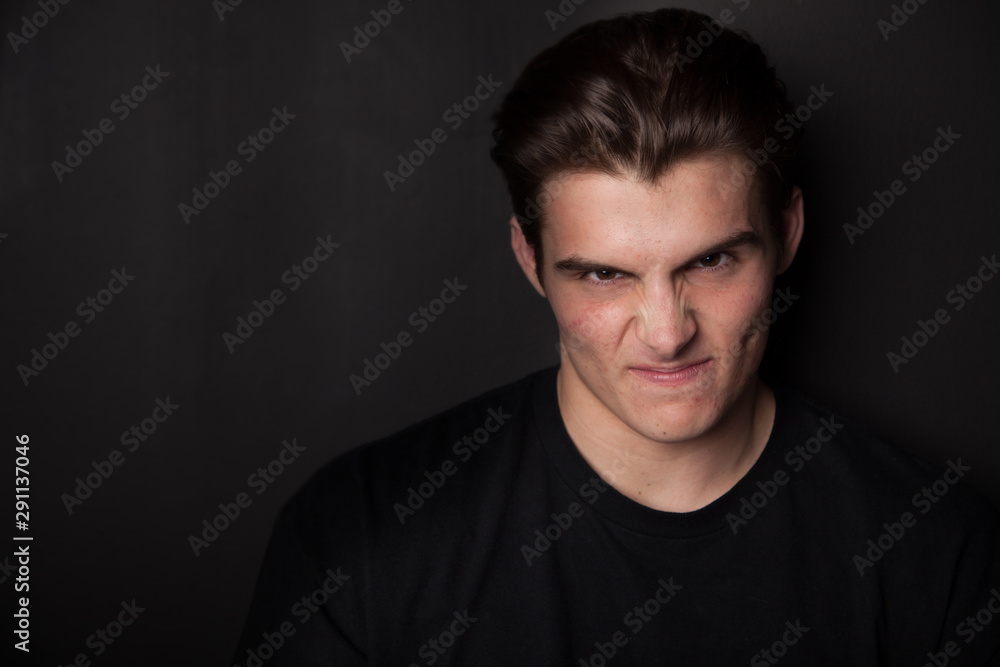 Agressive young man or teen looking angry