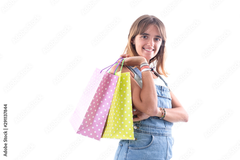 Young smiling woman with shopping bags against white background while looking camera Young smiling woman with shopping bags against white background while looking camera