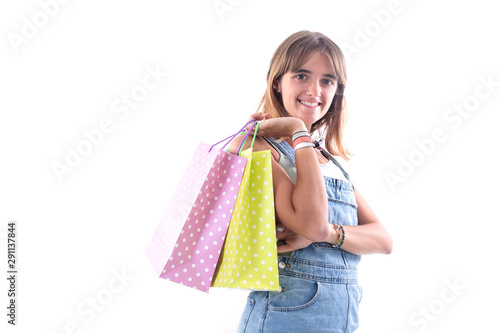 Young smiling woman with shopping bags against white background while looking camera