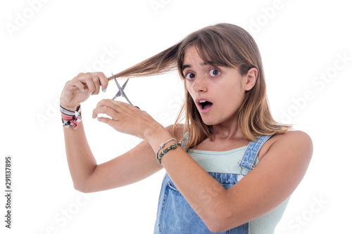 Young surprised woman with hair curlers over white background.