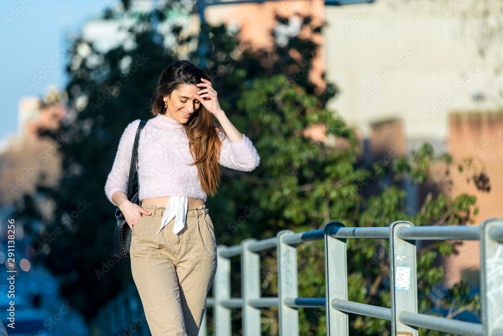 Fototapeta premium young beautiful woman in casual wear walking outdoors in the city