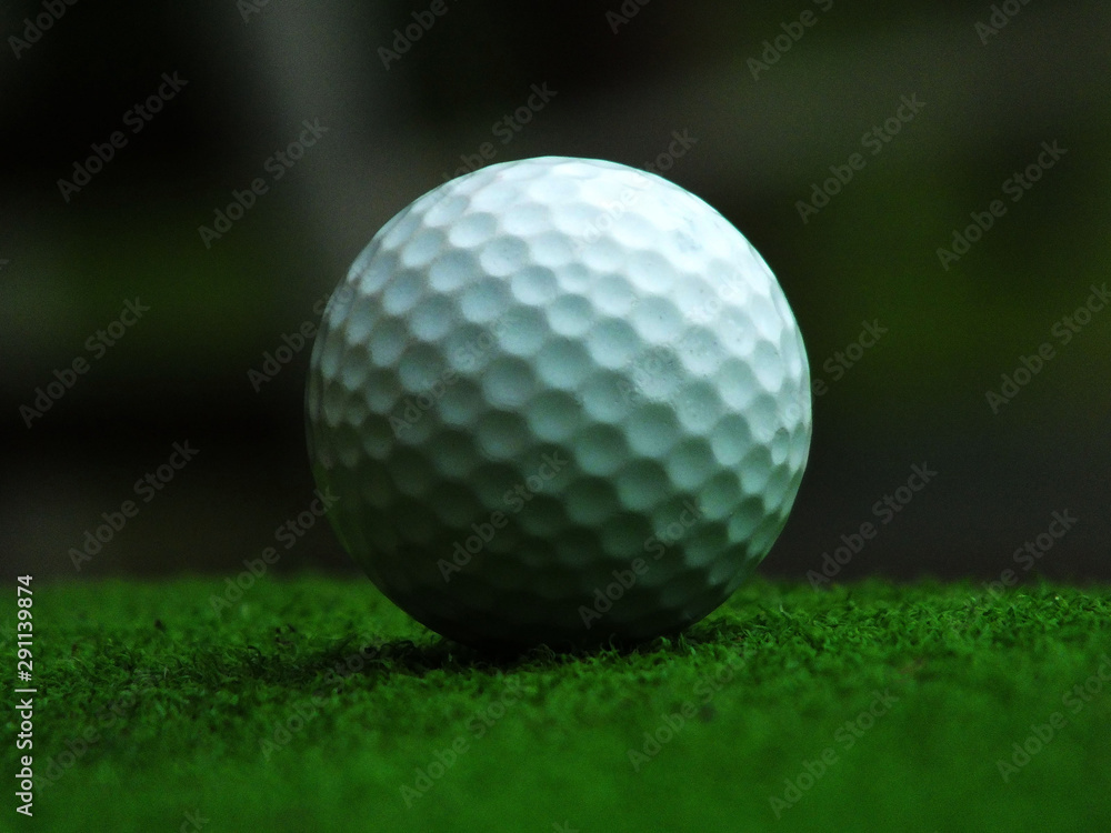 Obraz premium Golf on a green field with a natural sky background That is quite dark closely