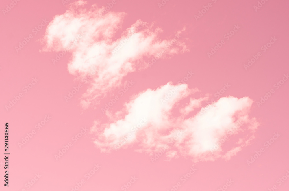 Pink sky and white clouds against blurred pattern background