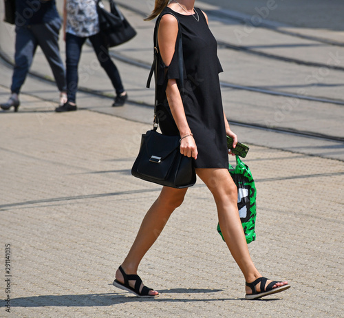 Yong woman walks on the city street