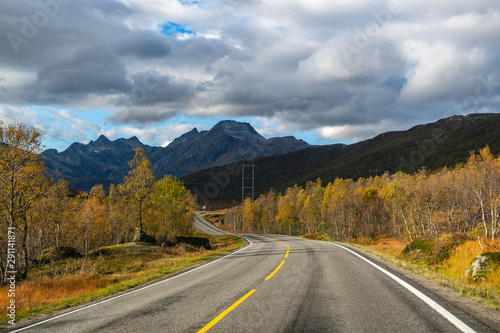 Scenic asphalt road through the beautiful view of mountain in lofoten island, Norway during autumn. Concept of roadtrip, travel, vacation, adventure