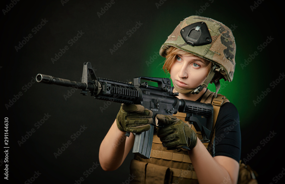 Fototapeta premium girl in uniform aims with a gun