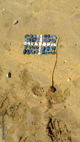 Cornish Flag of St. Piran made from stones and seaweed