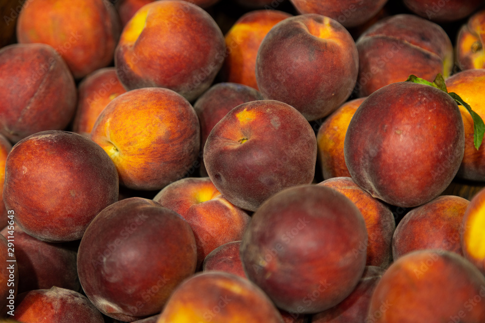 Close-up of ripe red-yellow peaches on supermarket counter Close-up of ripe red-yellow peaches on supermarket counter