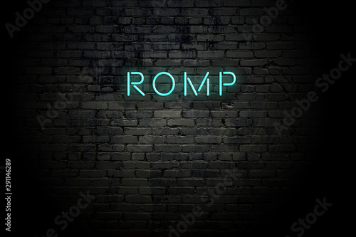 Fotografi Highlighted brick wall with neon inscription romp