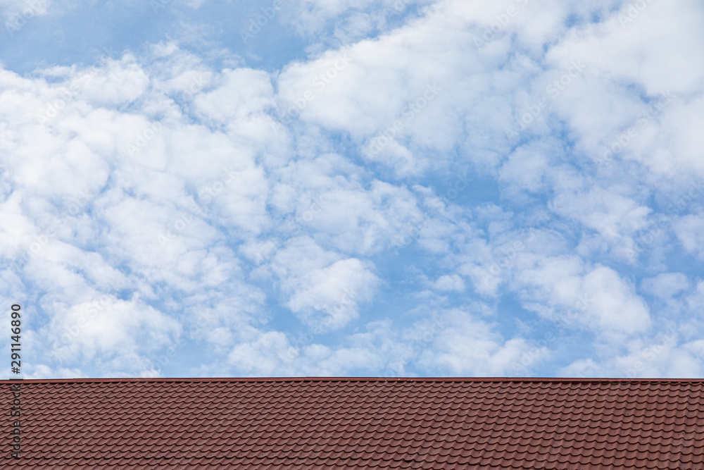 Red metal tile roof in front of sky Red metal tile roof in front of sky