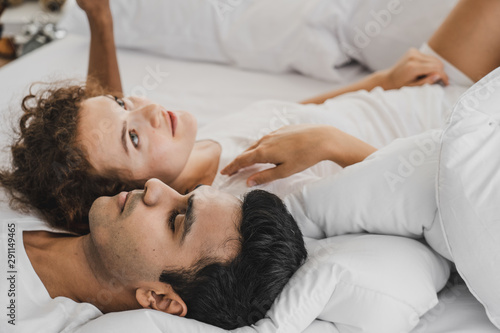 a man and a woman lying on a bed