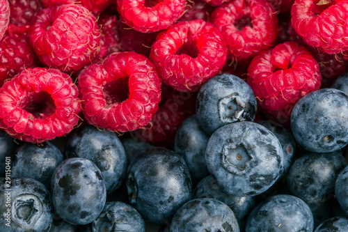Fresh Summer berries mix with raspberries and Blueberry on wood background.
