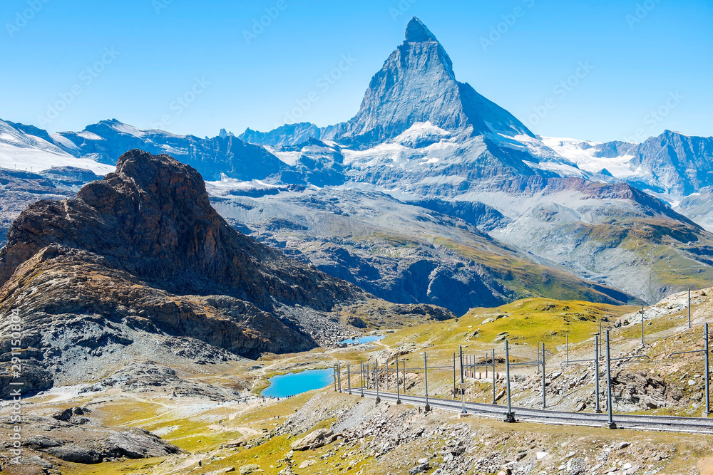 magnificent landscape in the Swiss Alps, in the foreground a railway, in the background a mountain Matterhorn