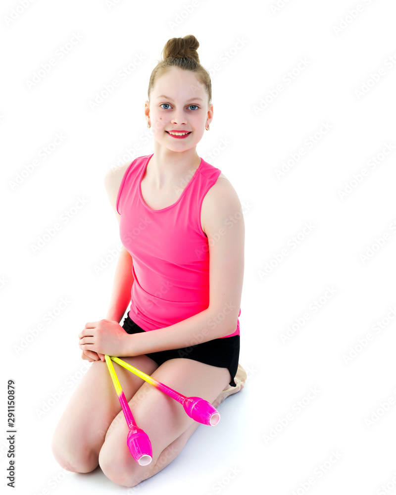 A girl gymnast performs exercises with a mace. A girl gymnast performs exercises with a mace.