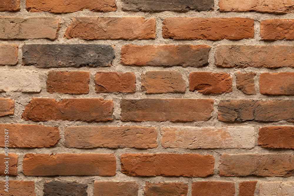Elevated view of brown and red flame brick wall - obrazy, fototapety, plakaty 