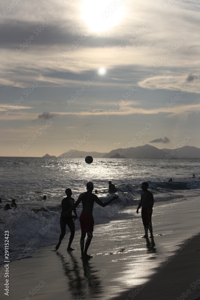 Football on the beach at sunset Football on the beach at sunset