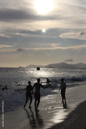 Football on the beach at sunset