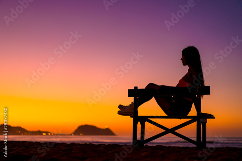 Zarautz, Gipuzkoa / Spain »; September 2019: Lifestyle, a girl sitting on a chair in summer sunset