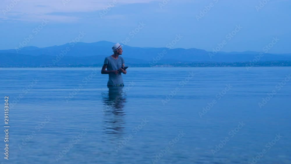 Freelancing guy working near the rocks and the sea. Business man on vacation in a tropical desert paradise. Preparing to pitch high in the mountains, on seaside. 4G, 5G connection background Freelancing guy working near the rocks and the sea. Business man on vacation in a tropical desert paradise. Preparing to pitch high in the mountains, on seaside. 4G, 5G connection background