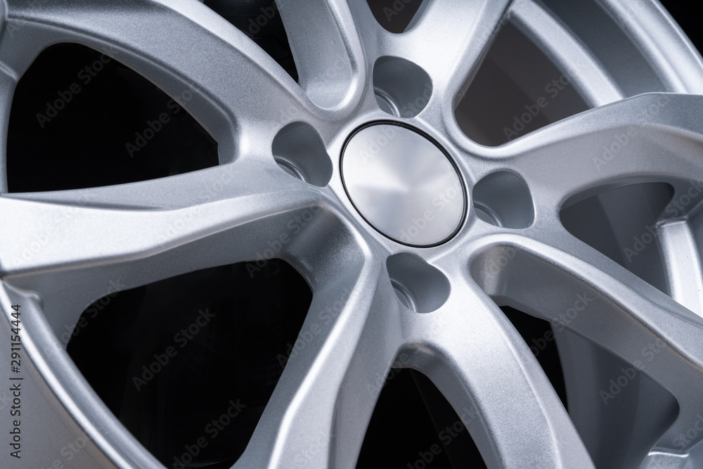 new car alloy wheel, over black background, close up the spokes of the disc new car alloy wheel, over black background, close up the spokes of the disc
