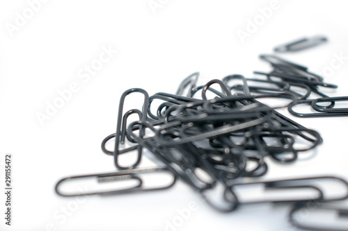 Clip for office accessories. Stationery. Black clips in a chaotic order. On a white background.