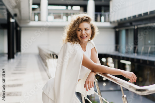 Black friday sale concept. Shopping woman holding white bag isolated. In aq huge modern mall.