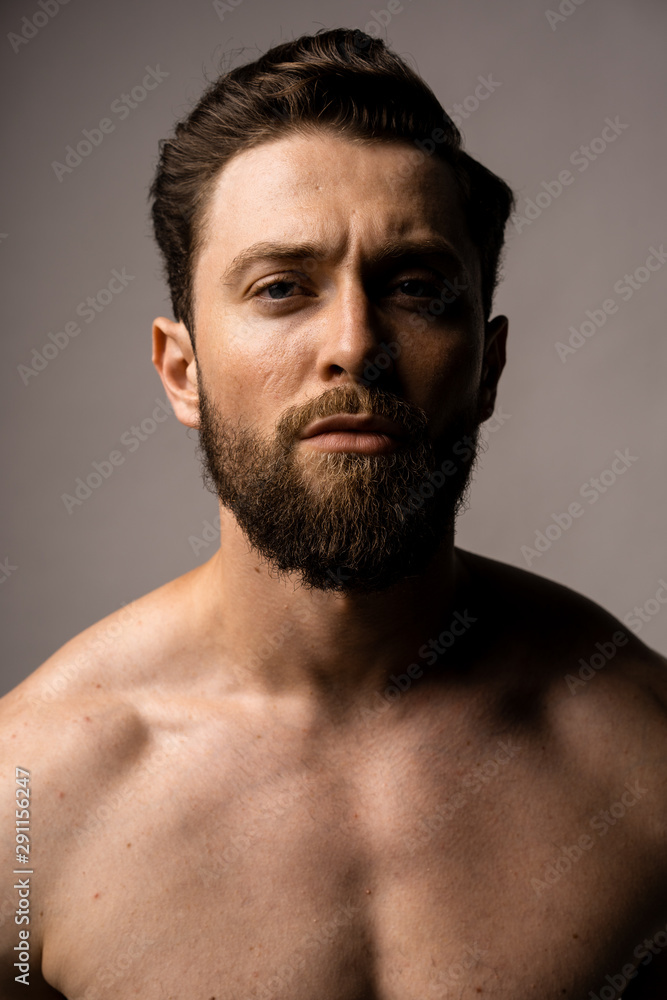 Handsome man in spectacles, portrait. Bearded guy without shirt. Strong eye contact. Handsome man in spectacles, portrait. Bearded guy without shirt. Strong eye contact.
