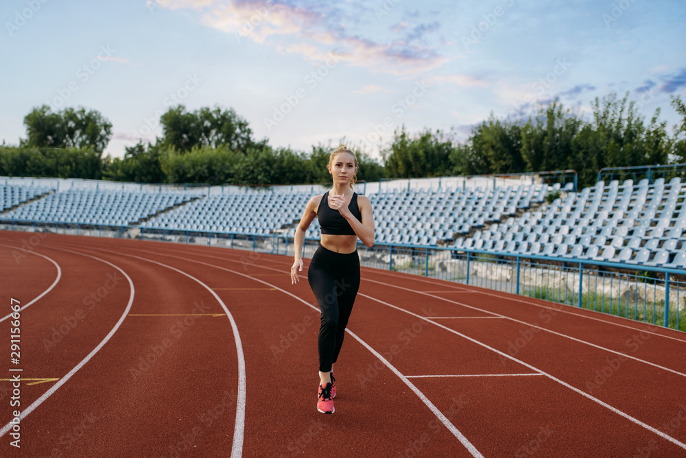 Fototapeta premium Female jogger running, training on stadium