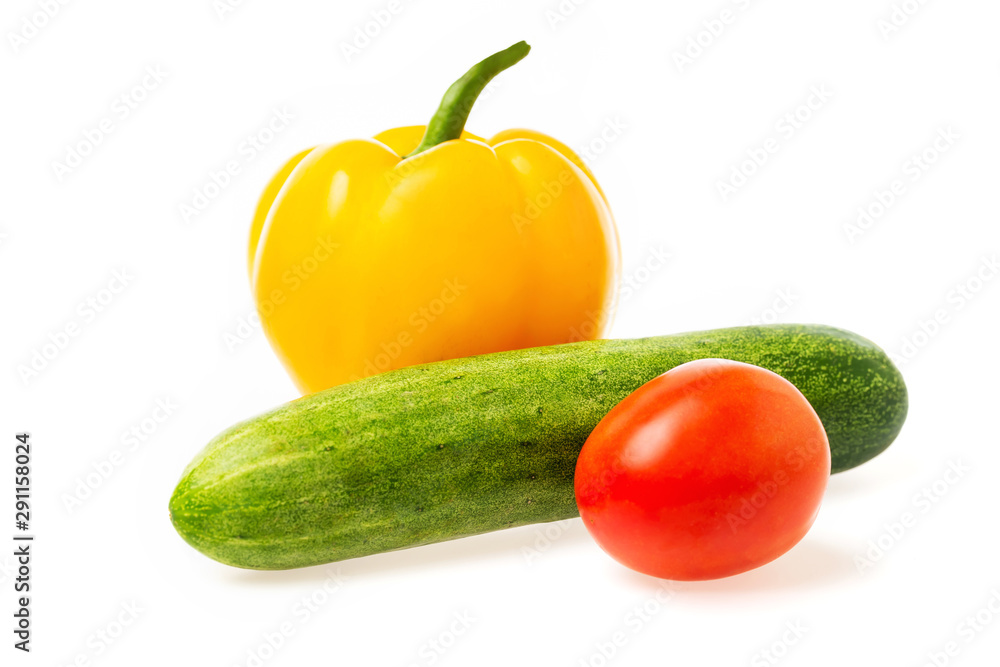 Closeup image of vegetables festive three colors group. Red tomato, green cucumber and yellow pepper isolated at white background. Closeup image of vegetables festive three colors group. Red tomato, green cucumber and yellow pepper isolated at white background.