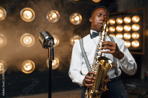 Male jazz performer plays the saxophone on stage