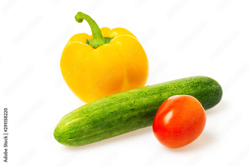 Closeup image of vegetables festive three colors group. Red tomato, green cucumber and yellow pepper isolated at white background. Closeup image of vegetables festive three colors group. Red tomato, green cucumber and yellow pepper isolated at white background.