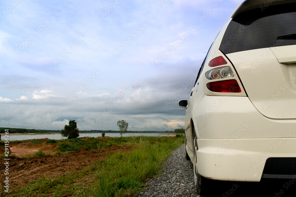 Back side of white car beside road travel at the road around of Ang Kep Nam Dok Krai Rayong Thailand.