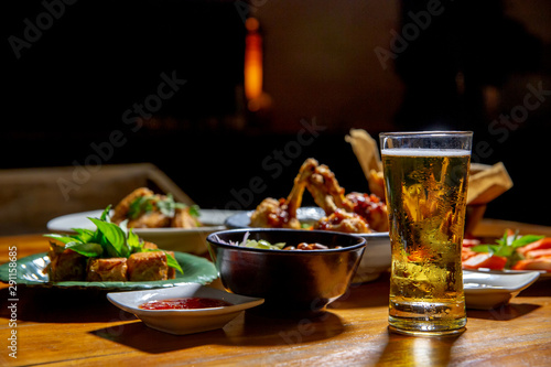Glass of beer and asian food.