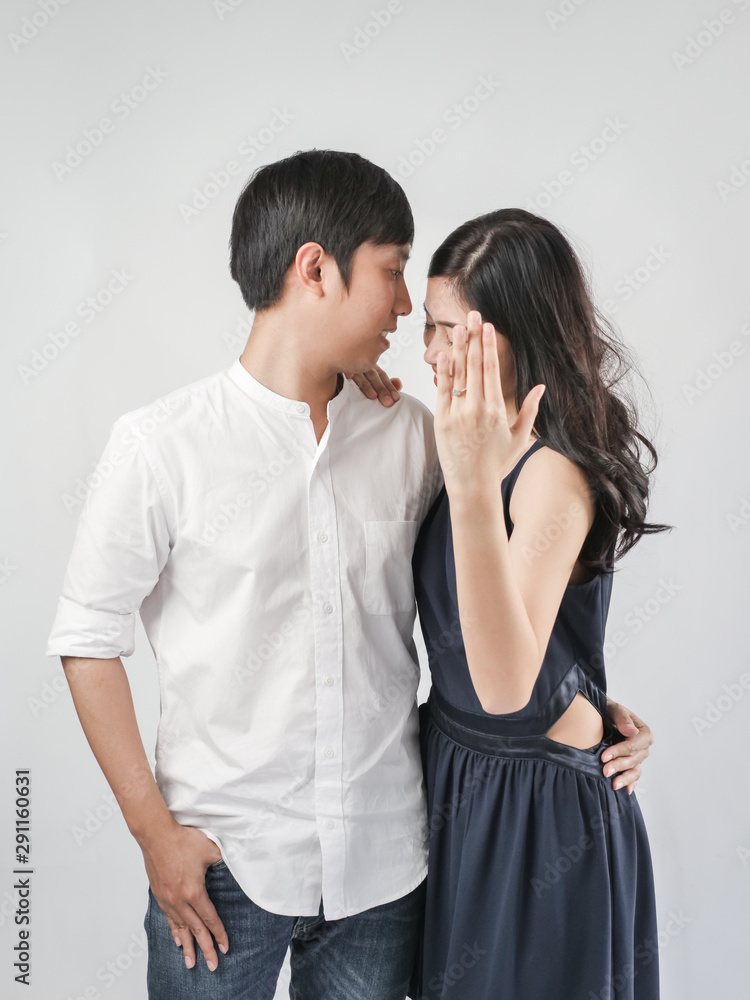 Happy woman showing engagement ring after proposal while is cuddling her boyfriend. Happy woman showing engagement ring after proposal while is cuddling her boyfriend.