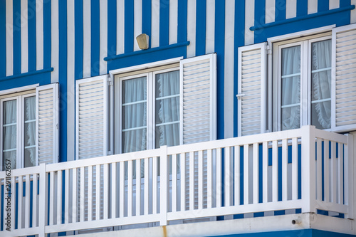 Detailed view of front facade windows and balcony of typical Costa Nova beach house