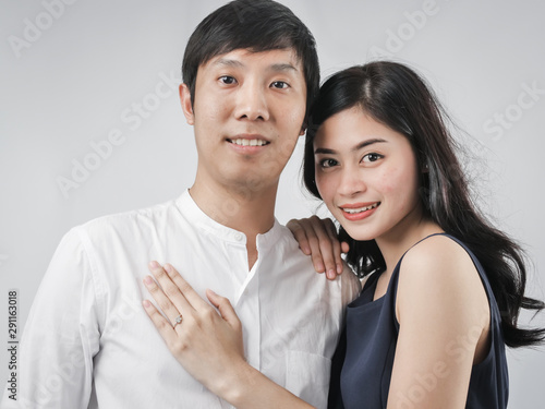 Asian couple hugging together with white background.