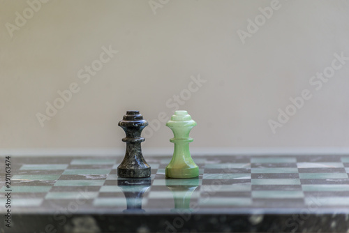 Marble chess pieces, on a marble chessboard. Closeup