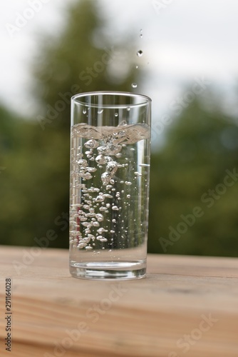 Transparent glass with water and air bubbles.