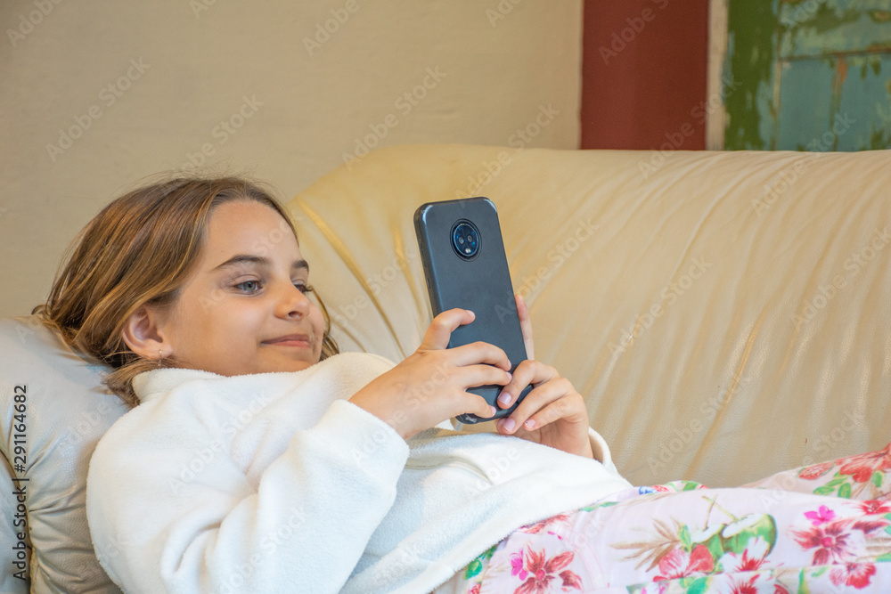 Young child lying with mobile phone in social network Young child lying with mobile phone in social network