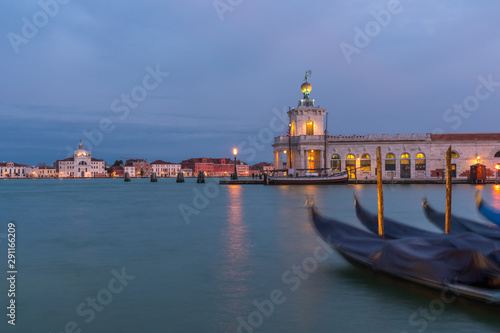 Gondolas and Punta della Dogana art gallery at night, Venice, Italy.