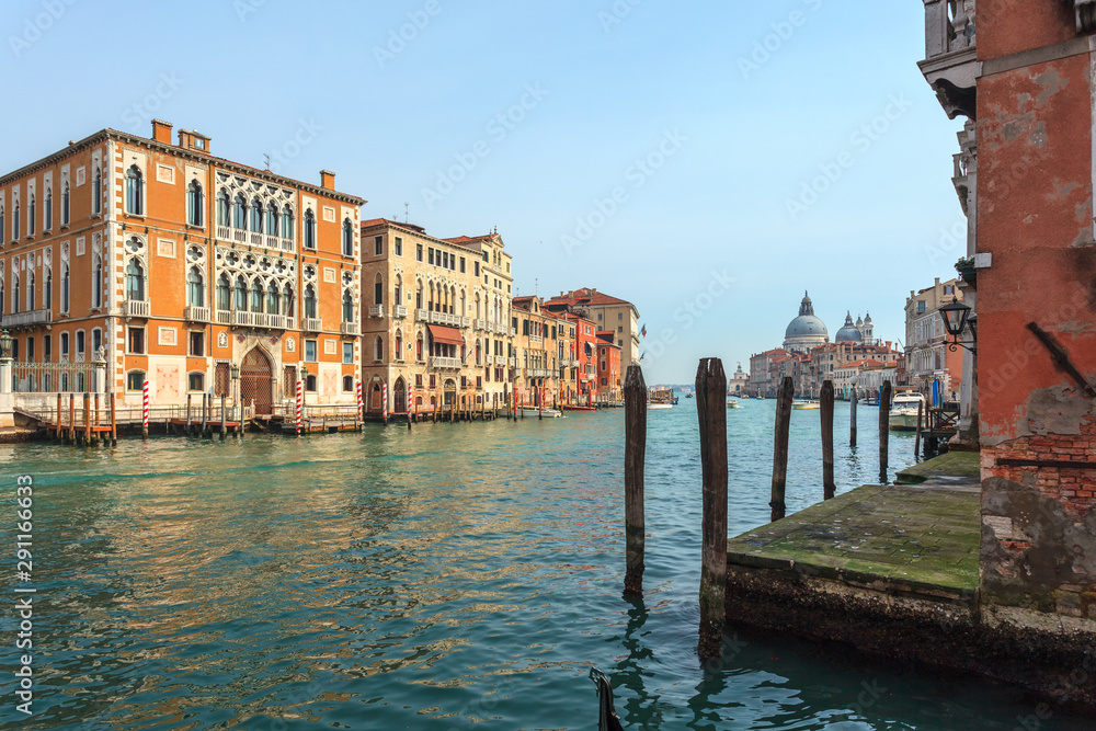 Fototapeta premium View of Canal Grande. Various boats float by a fine architectural complex of embankments.