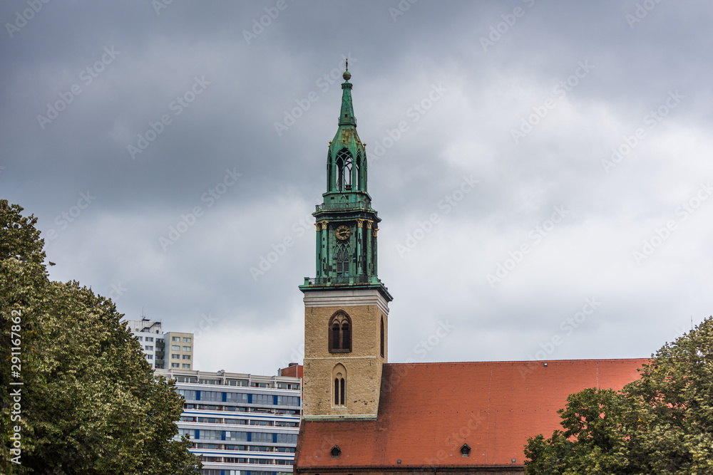  Bell Tower of St Mary's Church (Marienkirche) against cloudy sky. The church was originally a Roman Catholic church, but has been a Lutheran Protestant church since the Protestant Reformation.