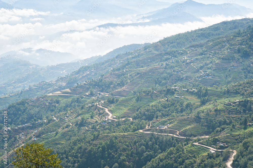 Looking at amazing view of clouds on the Himalayas and rice terraces in Nagarkot in Nepal. Nagarkot is a village in central Nepal, known for its views of the Himalayas, including Mount Everest.
