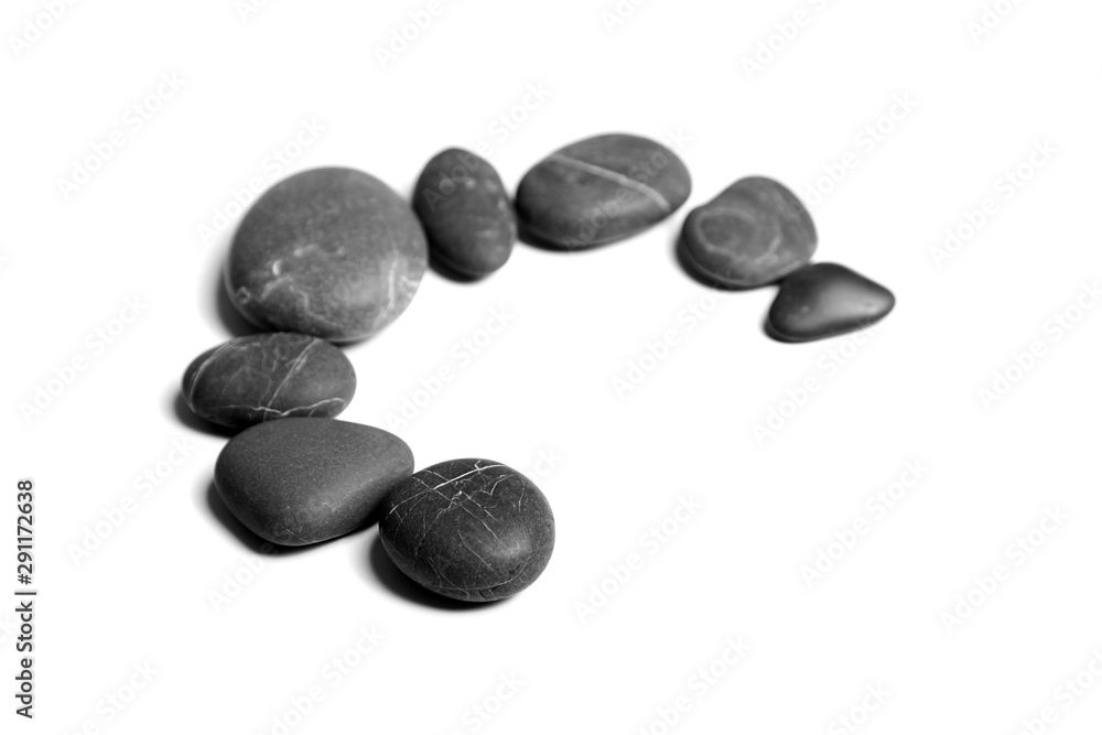 Scattered sea pebbles. Heap of smooth gray and black spa stones isolated on white background Scattered sea pebbles. Heap of smooth gray and black spa stones isolated on white background