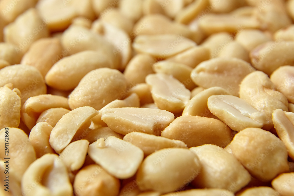 roasted peeled peanuts, salted snack as background. high calorie product roasted peeled peanuts, salted snack as background. high calorie product
