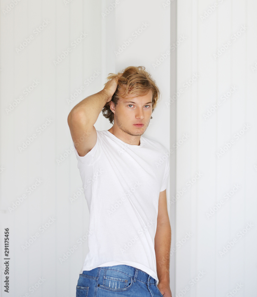 Teenager standing near white wall Teenager standing near white wall